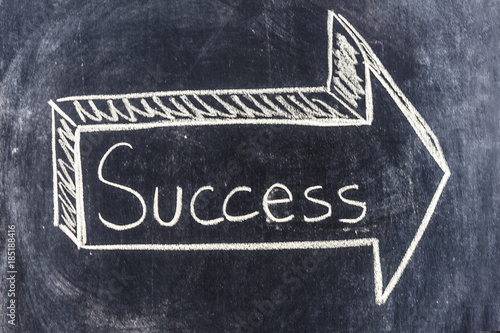 Arrow for success sketched on blackboard
