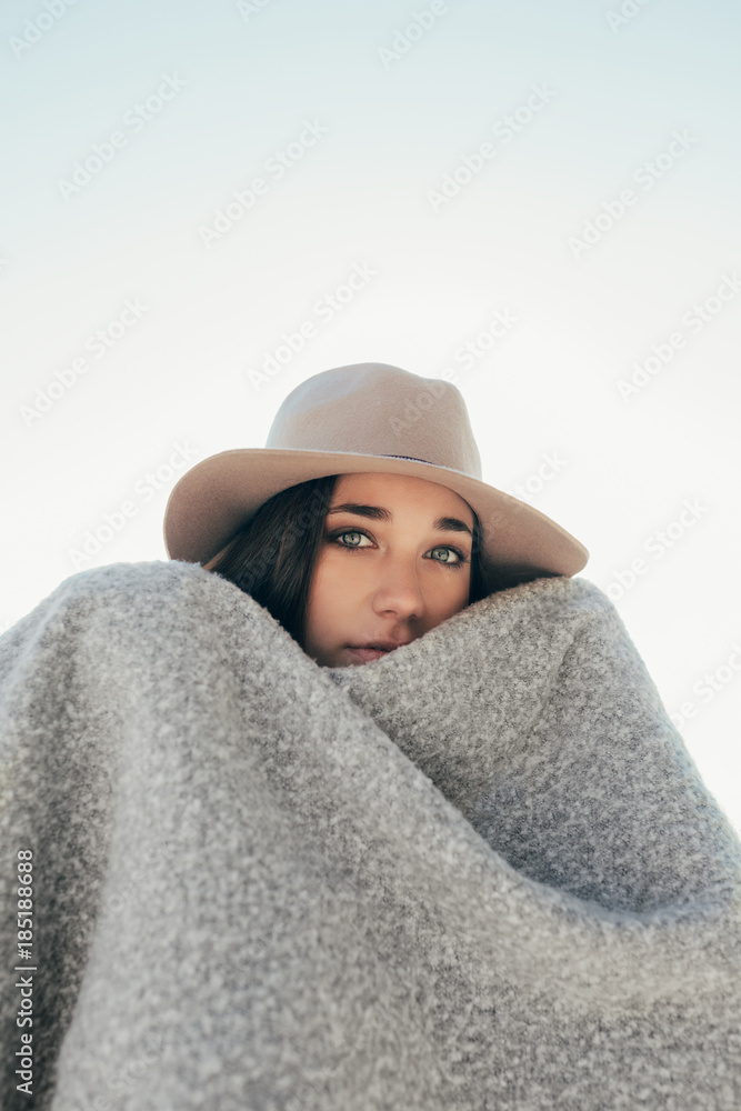 Black and white shot of a teen woman covered with a blanket Black and white shot of a teen woman covered with a blanket