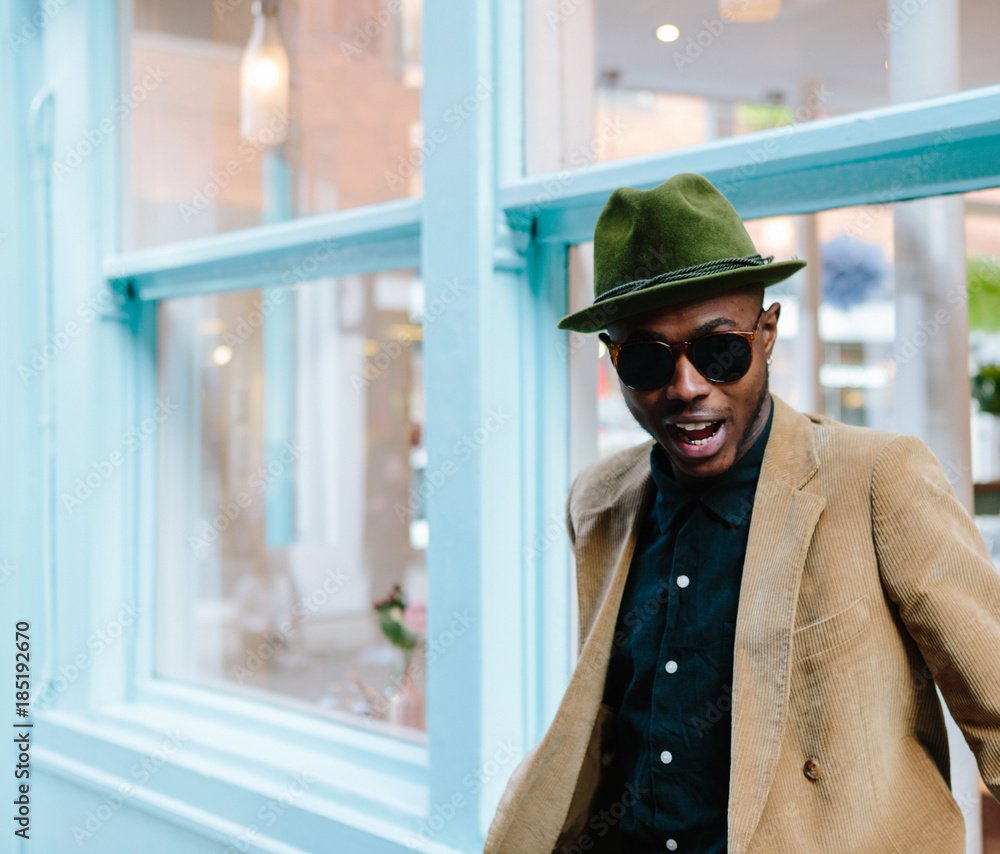 Stylish young black man with tattoos and hat Stylish young black man with tattoos and hat