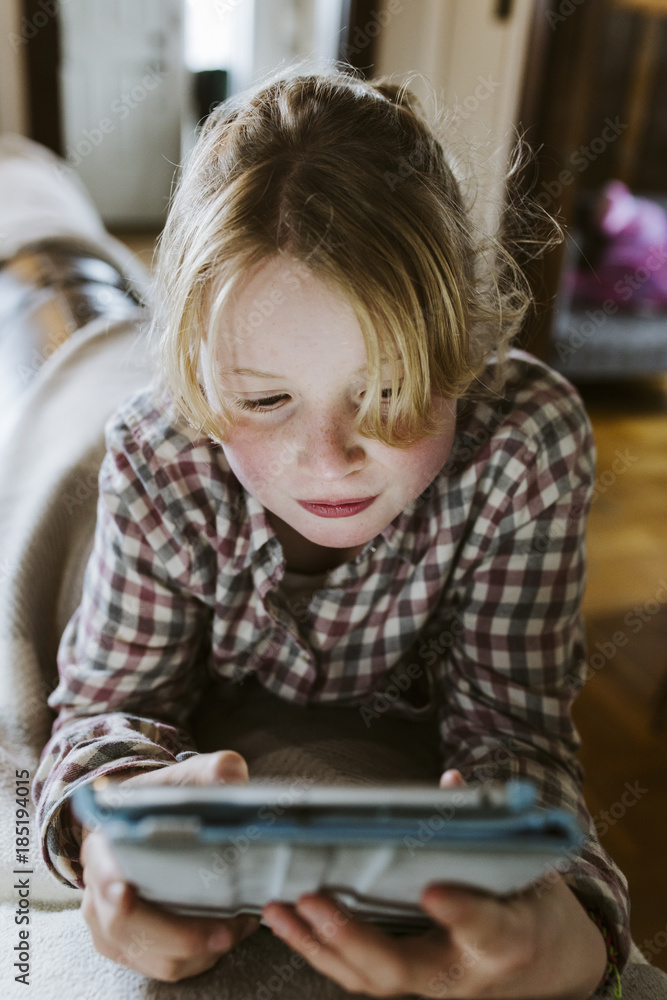 Young girl playing games on tablet Young girl playing games on tablet