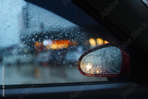 Rainy day on the road, Raindrops on car mirror with side wing mirror