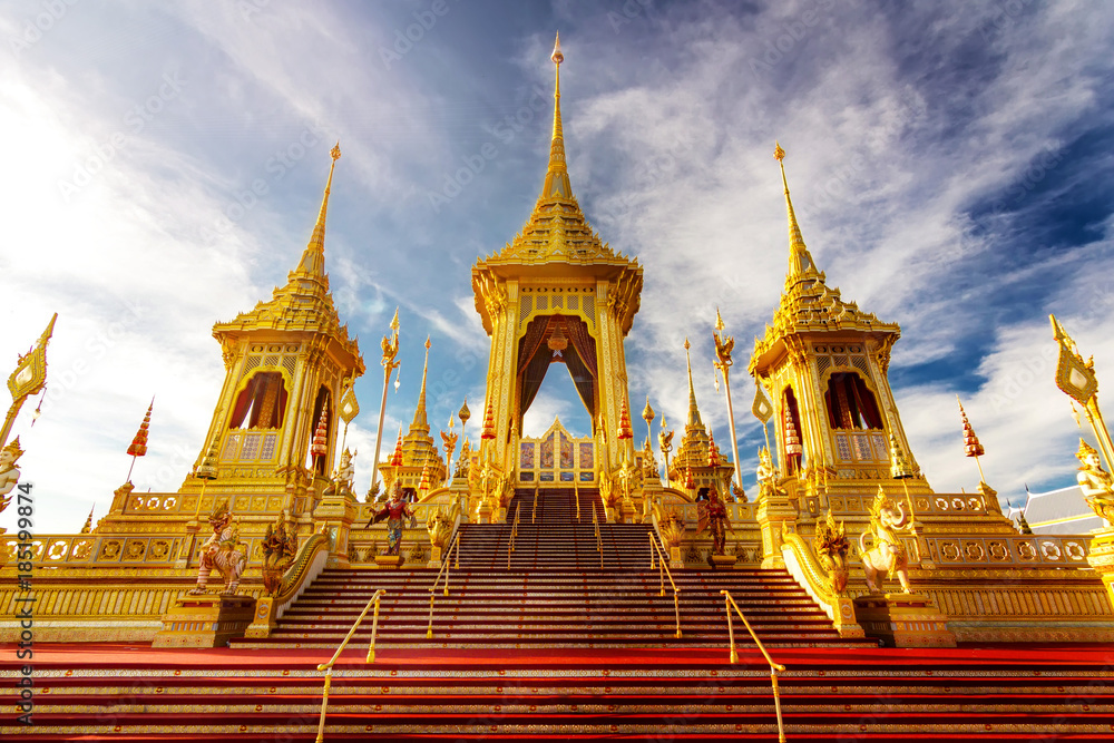Thailand Royal Crematorium. the golden royal pyre for royal funeral of His Majesty King Bhumibol Adulyadej is tourist attraction landmark in Bangkok with cloudy sunrise sky background landscape.