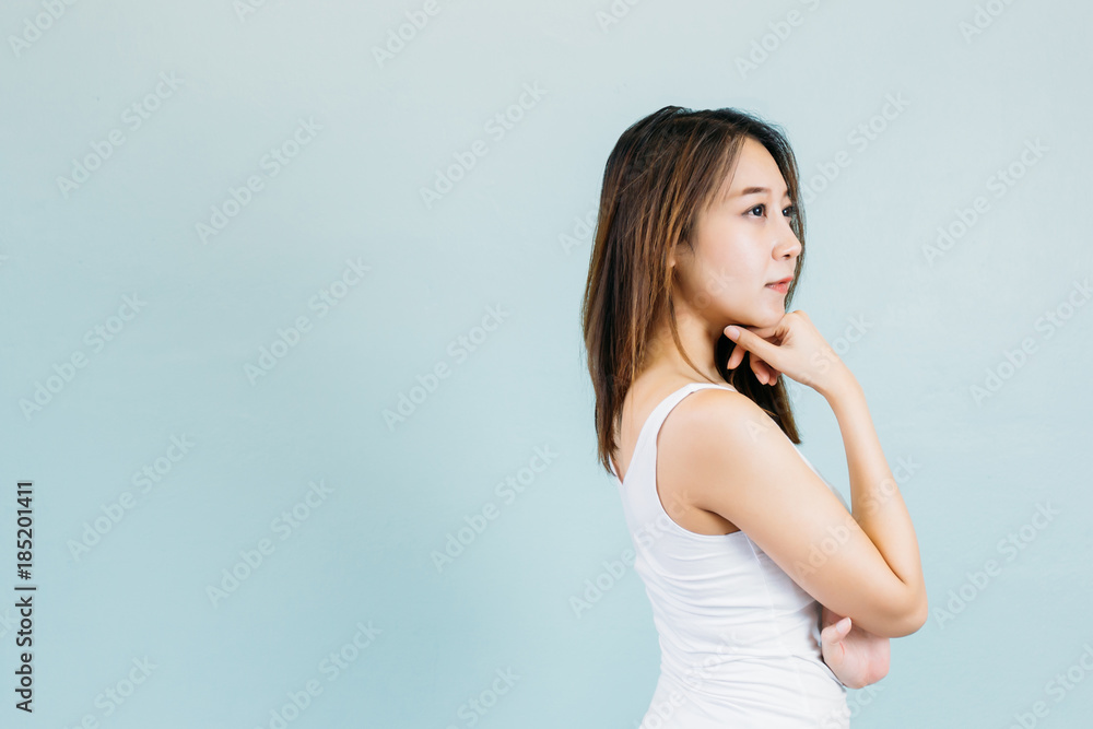 Attractive Asian woman thinking and arms crossed isolated on blue pastel background Attractive Asian woman thinking and arms crossed isolated on blue pastel background