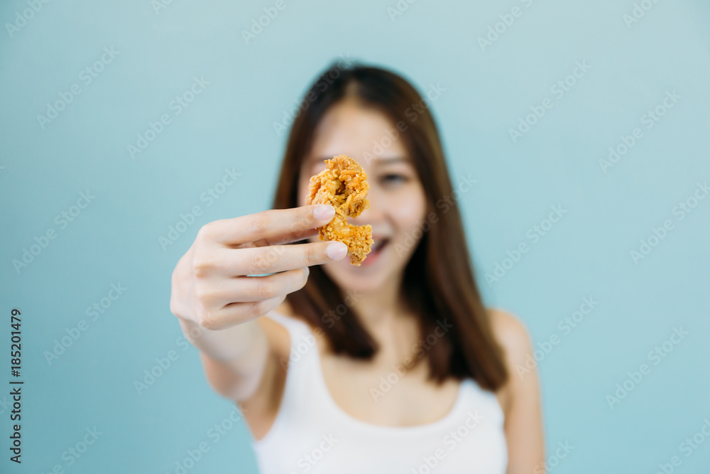 Asian woman with mouth opened eating eat deep fried chicken legs drumstick Asian woman with mouth opened eating eat deep fried chicken legs drumstick