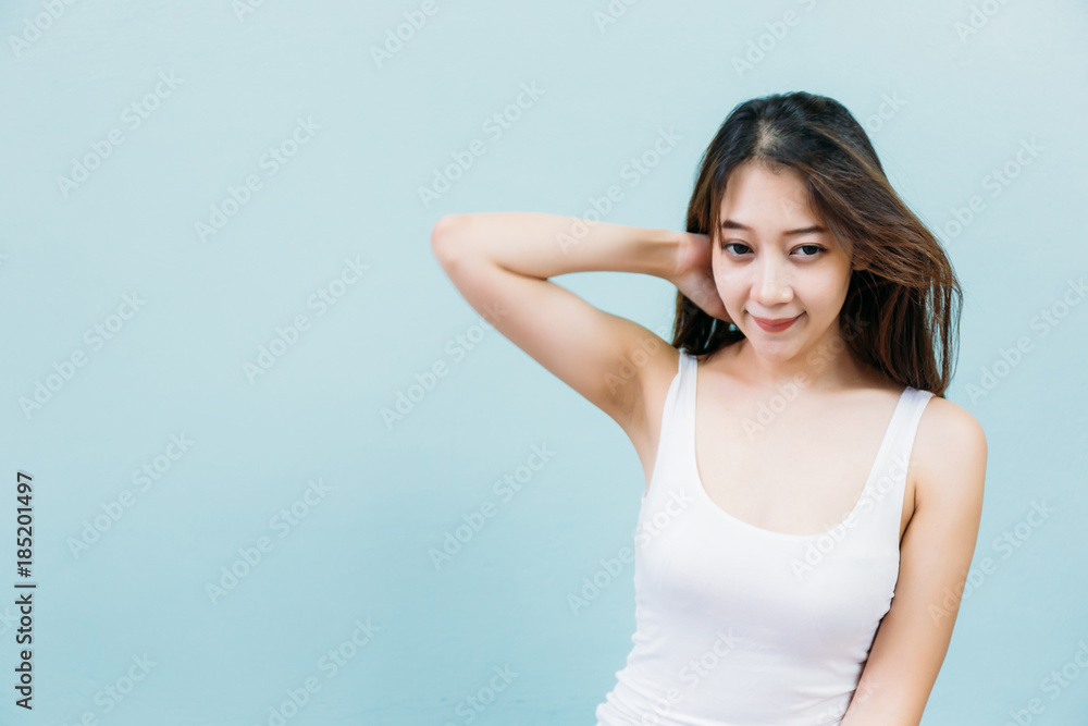 Happy young woman against blue pastel background Happy young woman against blue pastel background