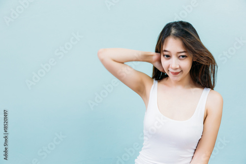 Happy young woman against blue pastel background