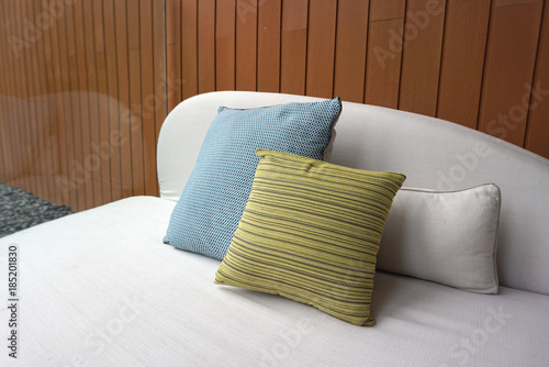 Fototapeta Naklejka Na Ścianę i Meble -  Lime color linear pattern cushion and blue color cushion on the outdoor sofa furniture