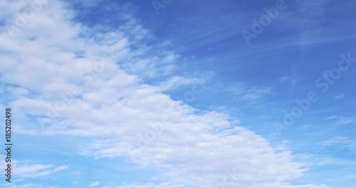 Thin, wispy ,white Cirrus clouds floating on a cold, brilliant winter sky with tints of blue