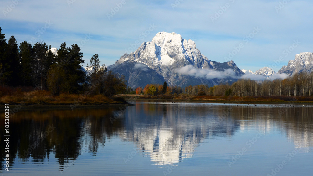 snow on mount moran with reflection
