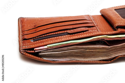 Close up Used Brown Leather Wallet with a full of banknote.