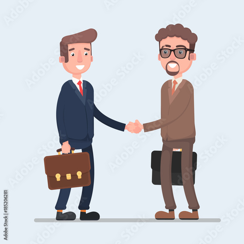 Two smiling businessmen shaking hands together.