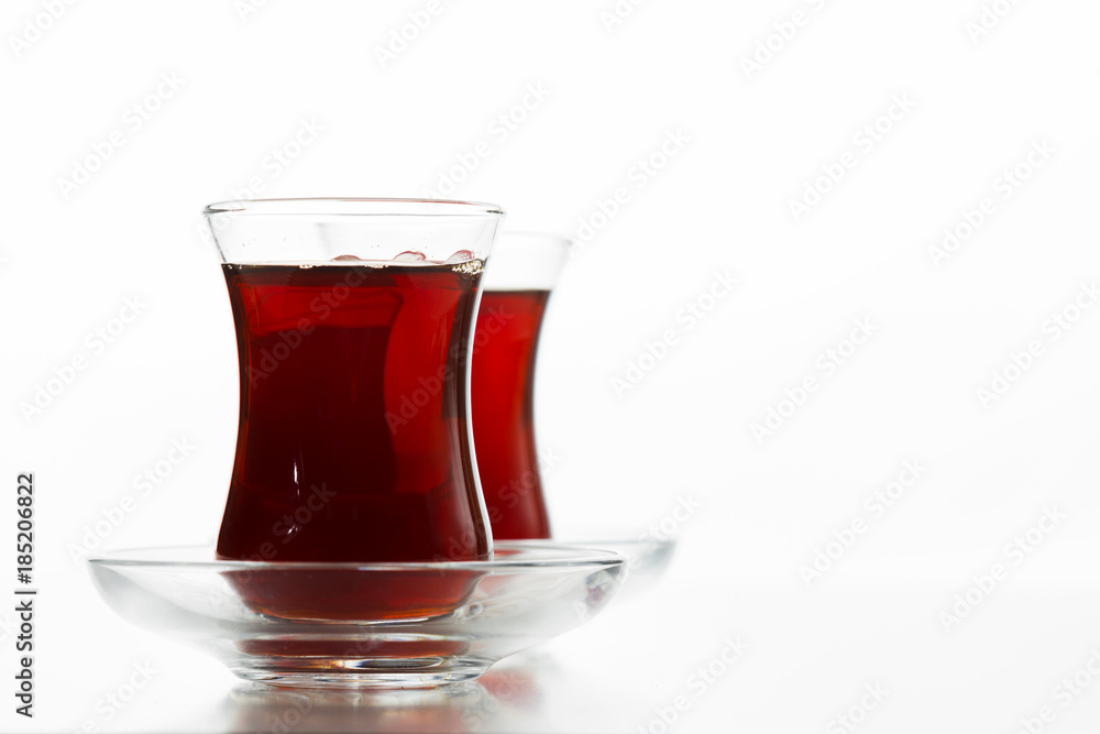Turkish tea in traditional glass isolated on white background Turkish tea in traditional glass isolated on white background