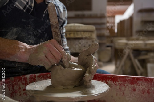Male potter making a pot in pottery workshop