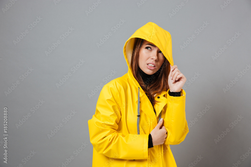 Portrait of an upset girl dressed in raincoat posing Portrait of an upset girl dressed in raincoat posing