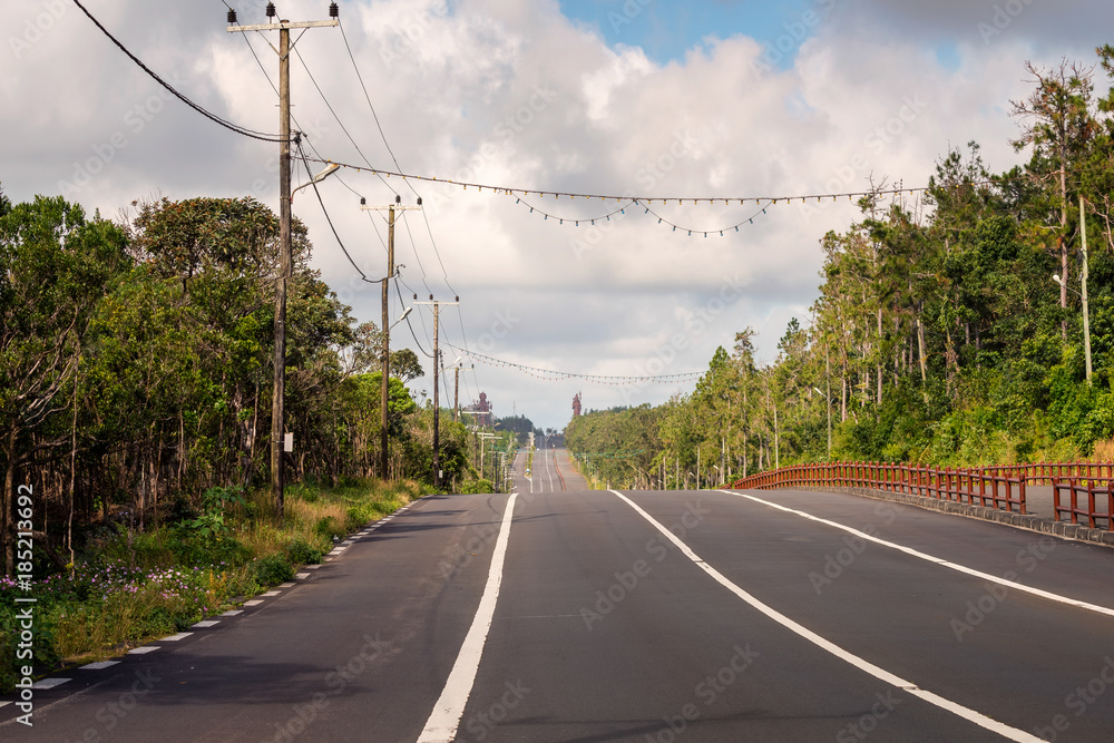 Fototapeta premium A big road to Grand Bassin lake at mauritius,background two huge staue of hindu religion. 