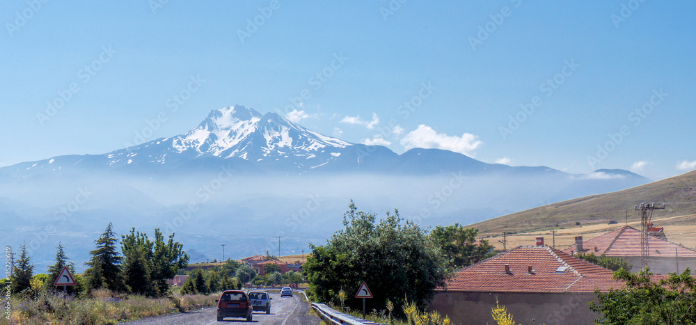 Naklejka premium Volcano Erciyes from a distance with a fog bank underneath the summit, Anatolia, Turkey