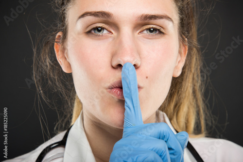 Close-up of young doctor portrait holding making sush gesture