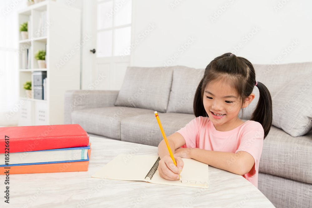 happy little girl doing school homework studying happy little girl doing school homework studying