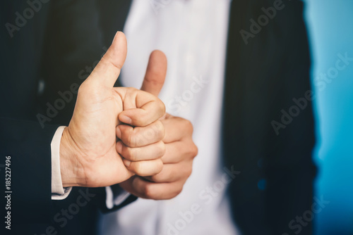 Businessman is lifting thumbs To display indescribably and agree to terms in business.