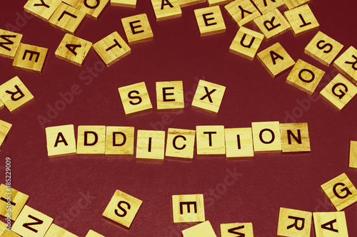 Wooden blocks on a red background spelling words Sex Addiction. Art style