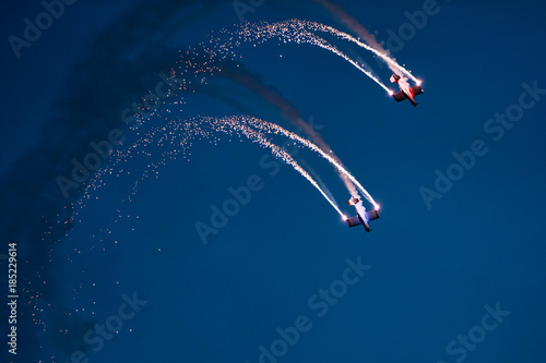 Bilde på lerret Two planes on the sky during the night airshow.