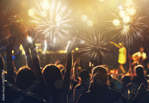 new Year concept - cheering crowd and fireworks