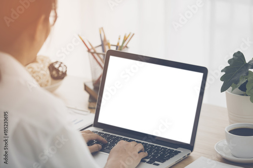 Cheerful business lady working on laptop comouter at home . photo