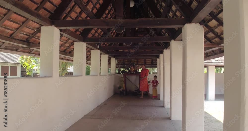 CHIANG MAI, THAILAND, MARCH 2017: Monk and young girl in conversation inside Thai Temple ground, outside Chiang Mai CHIANG MAI, THAILAND, MARCH 2017: Monk and young girl in conversation inside Thai Temple ground, outside Chiang Mai