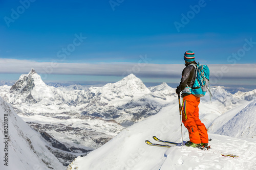 Young athletic man skiing on a sunny day with beautiful view of 