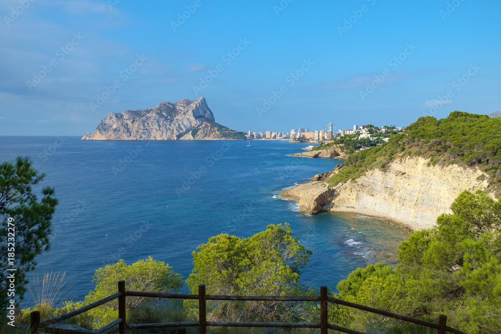 Obraz premium Calpe Rock seen from the Costa Blanca coastline between Calpe and Moraira, Spain.