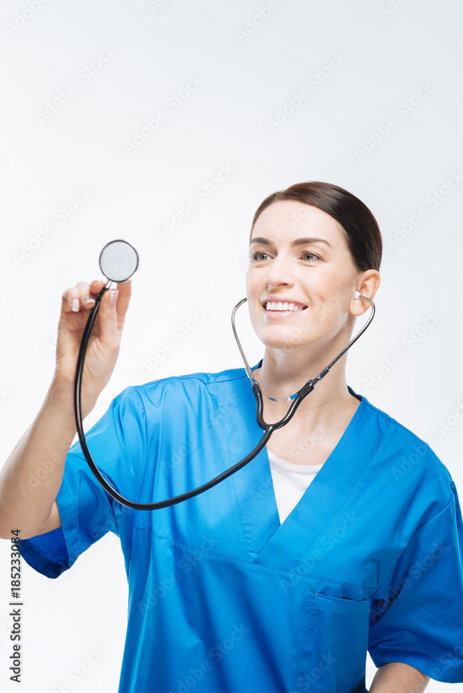Where pain. Elegant attractive female doctor holding stethoscope while diagnosing people and posing on the white background Where pain. Elegant attractive female doctor holding stethoscope while diagnosing people and posing on the white background