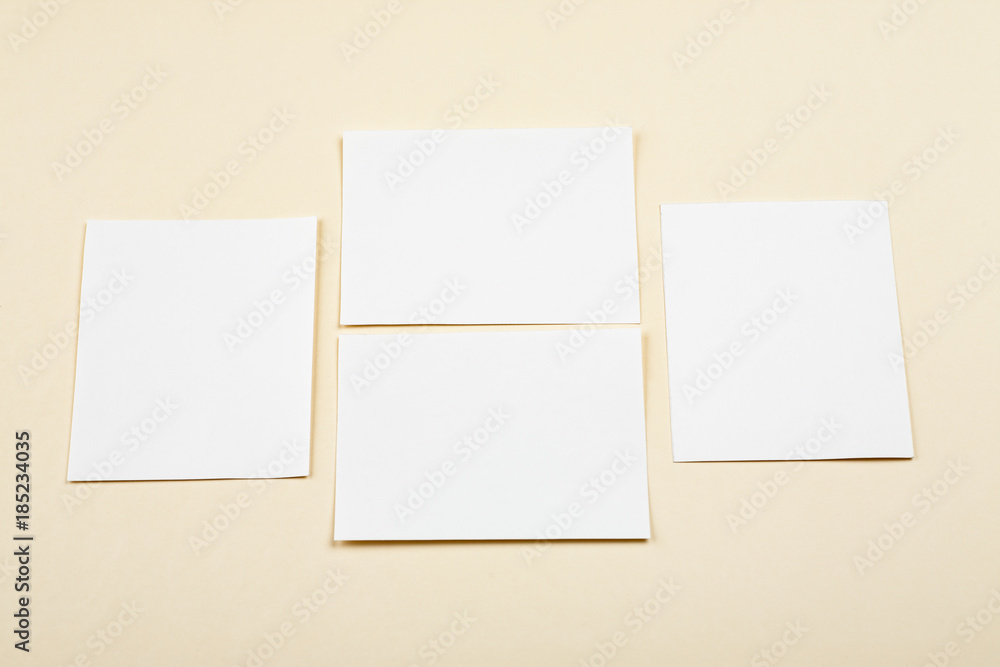 Blank white paper cards on a soft color background, business cards mockup Blank white paper cards on a soft color background, business cards mockup