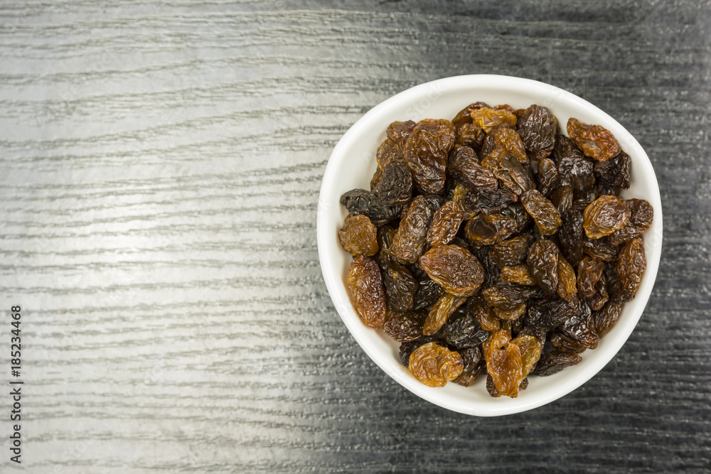 Fototapeta premium A bowl of raisins. View from above.