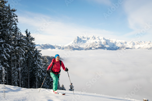 A woman does cross country skiing in fresh powder snow at Werfenweng near Salzburg.