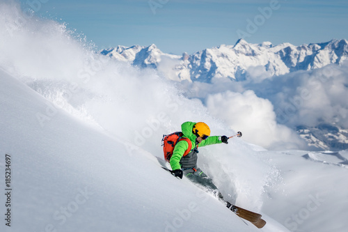 A male skier skiing in powder snow at the Kitzsteinhorn Glacier near Salzburg in Austria.