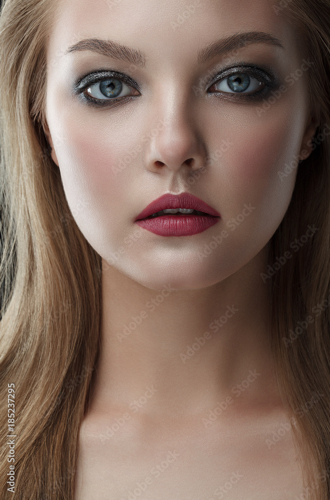 Closeup beauty portrait of young beautiful woman blond girl with long straight hair with natural makeup. Hairstyle and skincare and cosmetics concept Closeup beauty portrait of young beautiful woman blond girl with long straight hair with natural makeup. Hairstyle and skincare and cosmetics concept