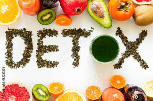 Healthy eating concept. Word 'detox' from green tea with colorful smoothies and fruits. Top view