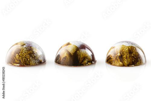 Colored handmade chocolate bonbons on white background