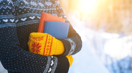 Books on the background of knitted sweaters.