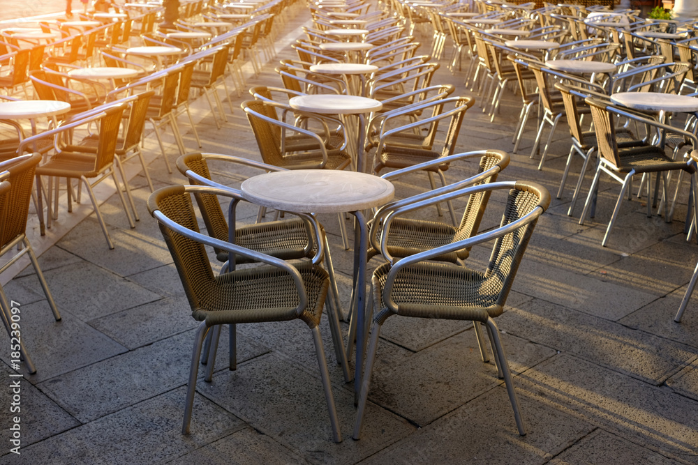 Naklejka premium Old european city street cafe table