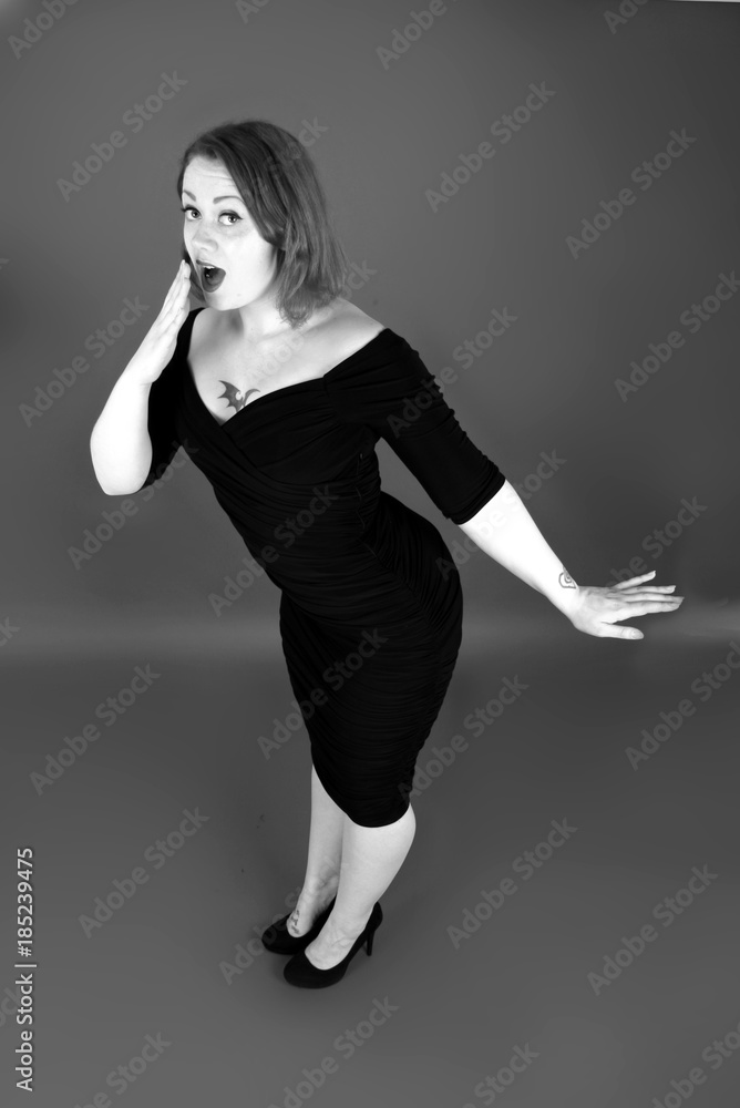 pin up girl in black wiggle dress, 1950s vintage fashion, retro style Stock  Photo