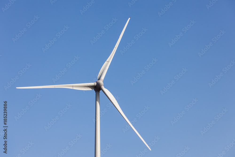 Wind power turbine close up view over blue sky Wind power turbine close up view over blue sky