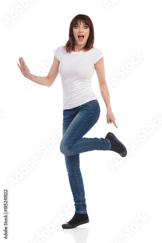 Surprised Woman Is Standing On One Leg And Pointing At Shoe