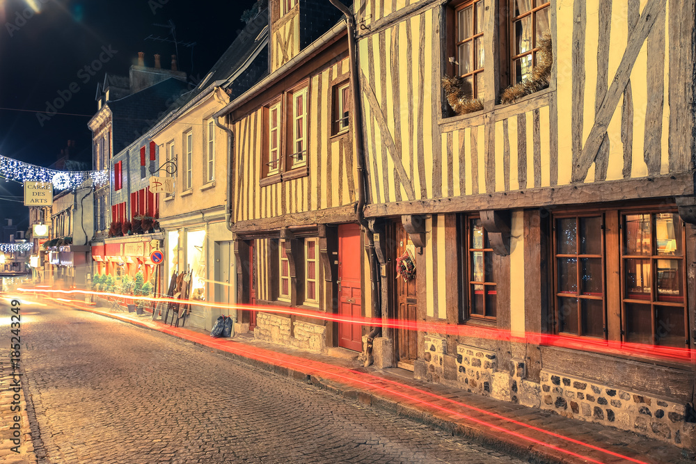 Street scene of houses of the old city centre with light trails in Honfleur, Normandy, France