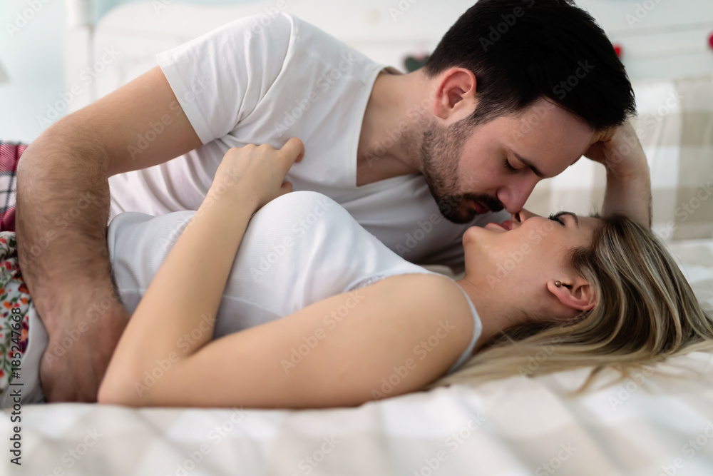 Young attractive couple having romantic time in bed Young attractive couple having romantic time in bed