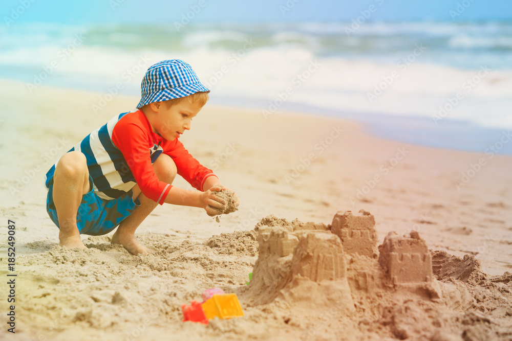 little boy play with sand on beach little boy play with sand on beach