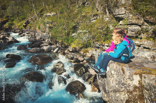 mother and son looking at waterfall  travel in Norway