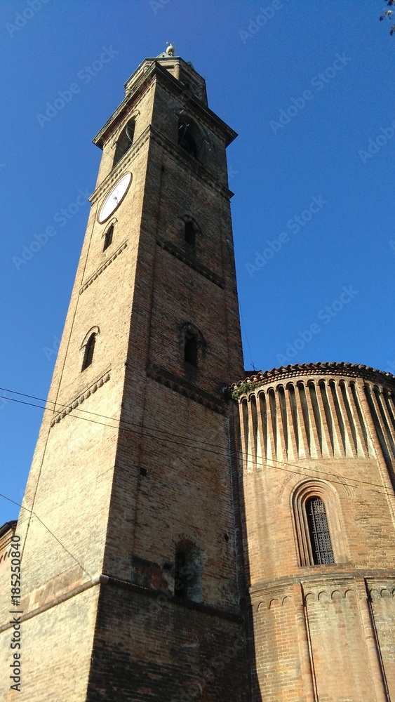 Tower bell and apse detail of San Michele Vetere romanesque church in Cremona