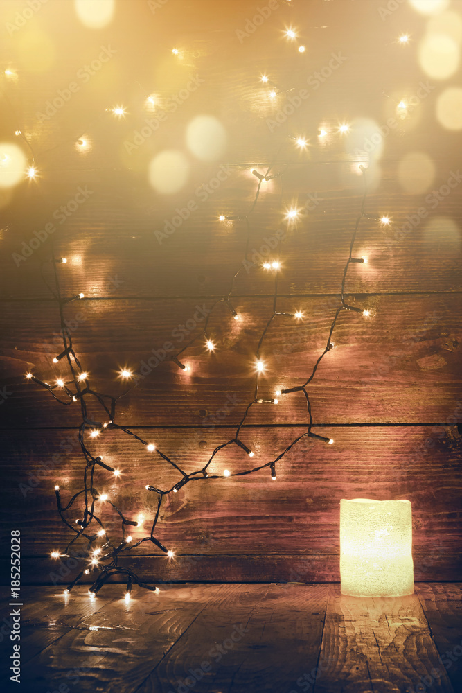 christmas decorations and lights on wooden background