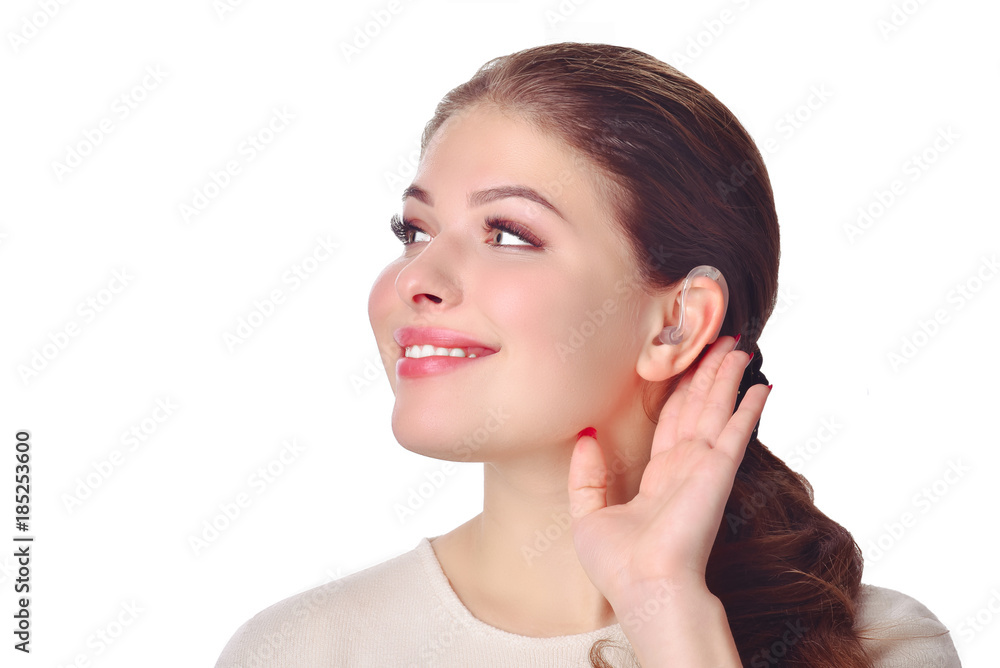 Cute girl with hearing aid looks aside and smile. At isolated white background. Cute girl with hearing aid looks aside and smile. At isolated white background.